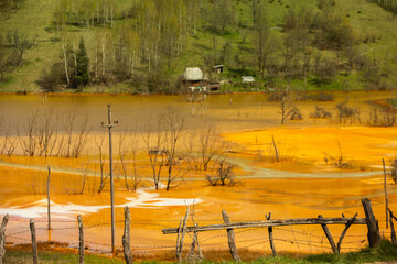 A lake contaminated with toxic waste in the western mountains of Romania. Nature pollution from copper mine. Ecological catastrophe or Environmental disaster
