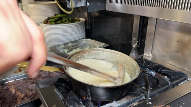 Melting butter in pan. The master melting butter for Iskender kebab
