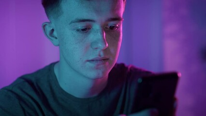 Young man typing on smartphone