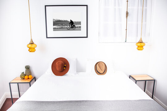 Two hats on bed in hotel room