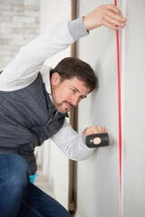 male builder revets panels for a facade of walls