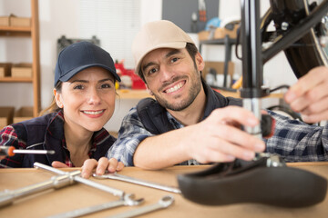male and female mechanics in bike garage
