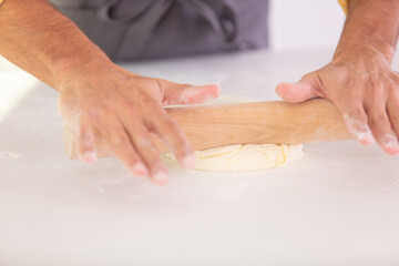 closeup man hands kneading dough