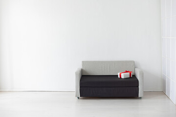 sofa with a gift on a white background interior in the room