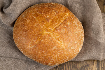 A whole loaf of round-shaped wheat bread