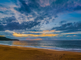 Sunrise seascape with clouds and gentle surf