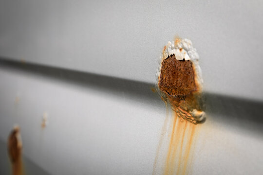 A rust spot on the car. Peeled paint