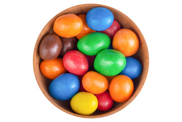 Multicolored glazed dragee in a wooden bowl isolated on transparent background.