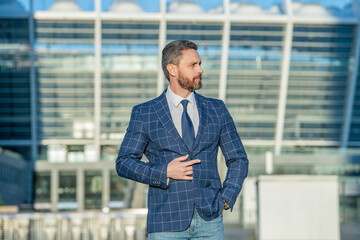 adult business executive wearing jacket in the street. photo of business executive with tie.