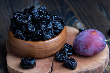 Black pile of prunes from a large number of ripe plums