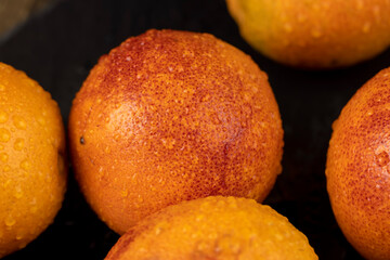 yellow-red orange peel covered with water drops