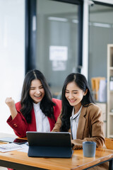 Young Asian business team creative businesspeople coworker, teamwork celebrating achievement and in planning design in office.