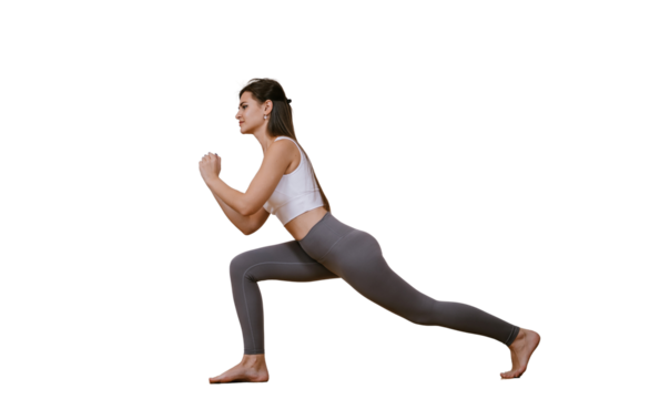 Brunette caucasian young woman in sportswear practicing yoga at home, makes lunges against transparent background. Fit American girl warms up at fitness class before training. Sport and fitness.