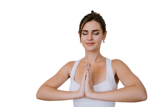 Beautiful brunette American girl in sportswear meditating with hands in prayer gesture against transparent background. Focused young caucasian woman concentrating on her goals preparing for yoga class