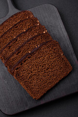 Delicious fresh brown bread with grains and seeds sliced on a wooden cutting board