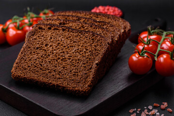 Delicious fresh brown bread with grains and seeds sliced on a wooden cutting board