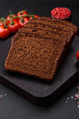 Delicious fresh brown bread with grains and seeds sliced on a wooden cutting board