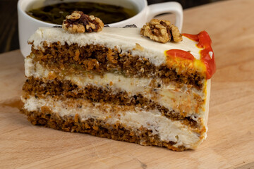 a cut piece of multi-layered honey cake with creamy filling