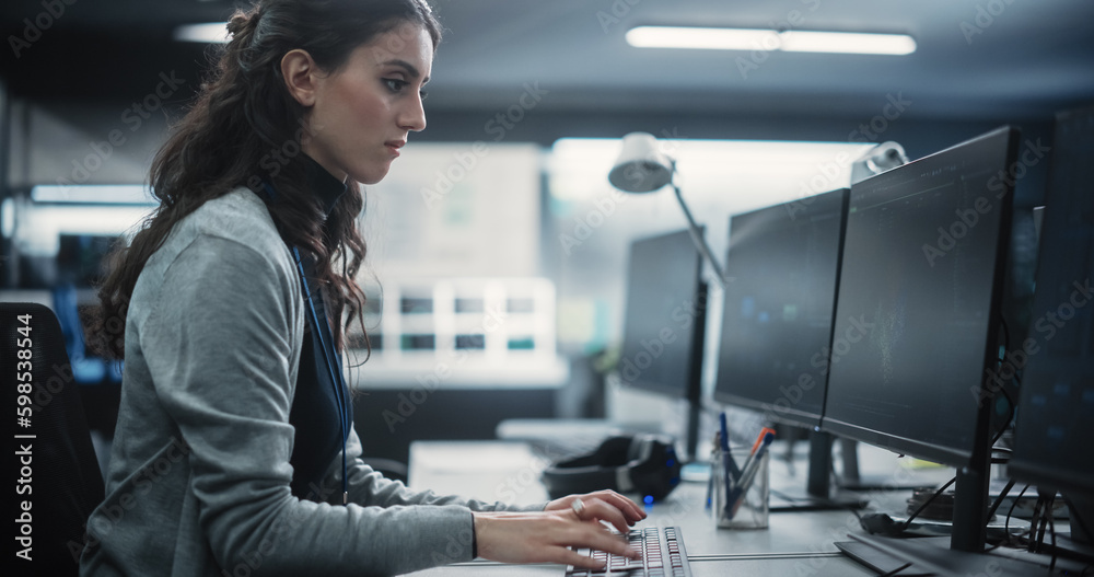 Fototapete Young Female Artificial Intelligence Engineer Working on Computer in a Technological Office. Young Specialist Writing Software Code for an Innovative Big Data Blockchain Project