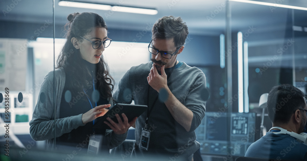 Aufkleber Portrait of Two Creative Young Female and Male Engineers Using Tablet Computer to Analyze and Discuss How to Proceed with the Artificial Intelligence Software. Standing in High Tech Research Office