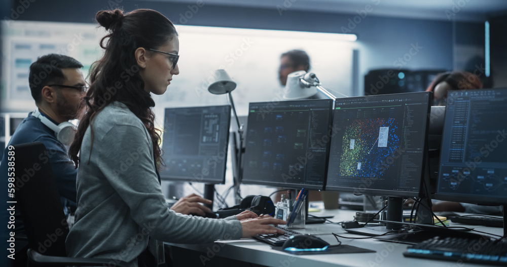 Aufkleber Young Female Artificial Intelligence Engineer Working on Computer in a Technological Office. Young Specialist Writing Software Code for an Innovative Big Data Blockchain Project. Photo from the Back