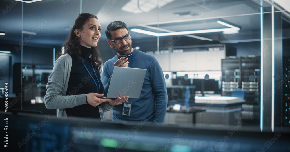 Poster Portrait of Two Happy Female and Male Engineers Using Laptop Computer to Analyze and Discuss How to Proceed with the Artificial Intelligence Software. Casually Chatting in High Tech Research Office