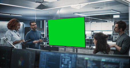 Group of Multiethnic Software Developers Having a Meeting in a Conference Room with Green Screen...
