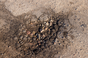 a damaged paved road with a lot of holes