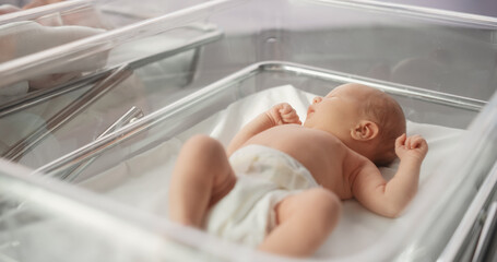 Cute Emotional Newborn Little Infant Lying in Hospital Cot. Funny Yawning Caucasian Baby Spending Time in Maternity Clinic, Getting Ready for Sleep. Healthcare, Pregnancy and Motherhood Concept