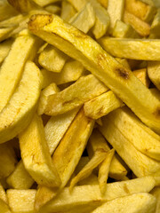 Fries in oil. Freshly baked potato chips. food background