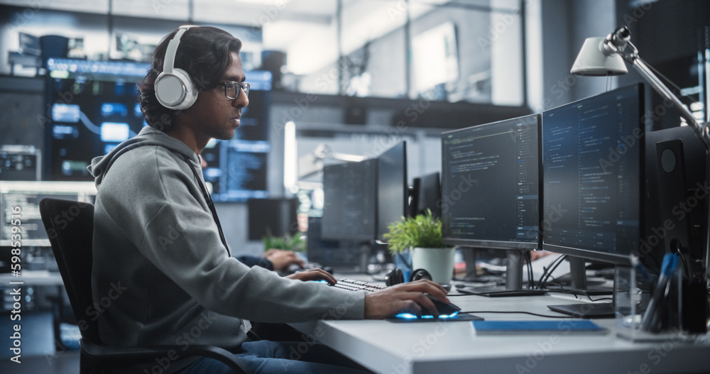 Aufkleber System Administrator Working in a Research E-Business Facility on a Desktop Computer. Focused Software Developer in Casual Clothes Wearing Headphones and Updating Server System Database