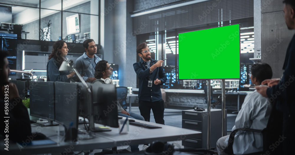 Poster Group of Multiethnic Software Developers Having a Meeting in a Conference Room with Green Screen Mock Up Display. Indian Specialists Brainstorming New Ideas and Solving Problems in the Office