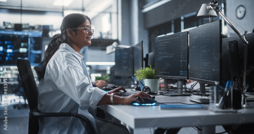Poster Young Female Artificial Intelligence Engineer Working on Computer in a Technological Office. Young Indian Specialist Writing Software Code for an Innovative Big Data Blockchain Project