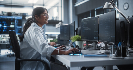 Young Female Artificial Intelligence Engineer Working on Computer in a Technological Office. Young Indian Specialist Writing Software Code for an Innovative Big Data Blockchain Project - obrazy, fototapety, plakaty