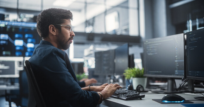 Young Creative Manager Using Computer, Writing a Project Plan for an Innovative Technological Internet Product Launch. Diverse Multicultural Team Working in a Startup Company