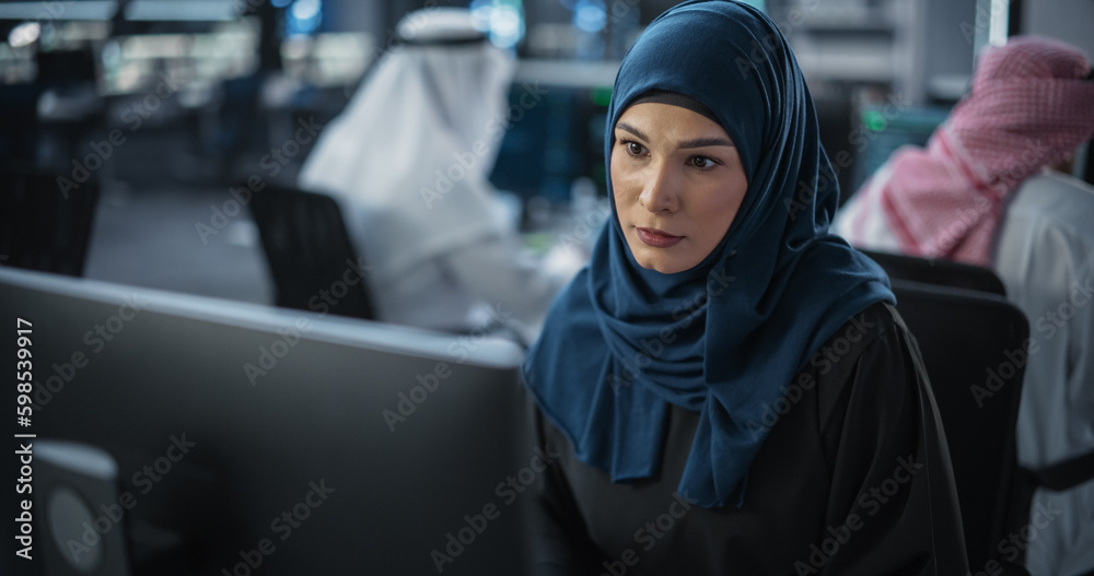 Aufkleber Portrait of a Thoughtful Middle Eastern Engineer Working on Computer in a Technological Corporate Office. Young Woman Writing Software Code for an Innovative Internet and Software as a Service Project