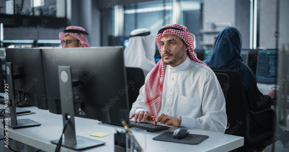 Fototapete Team of Talented Young Middle Eastern Professionals Working in a Technological Research and Development Agency. Computer Screens with Software Code and Technical Neural Network Diagrams