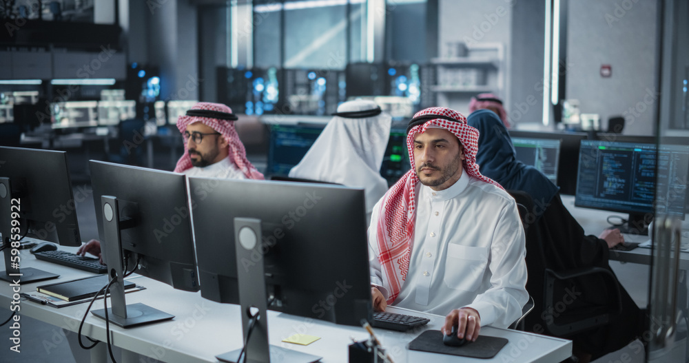 Aufkleber Diverse Young Arab Colleagues Working on Computers in a Research Laboratory. Focus on Muslim Male Software Developer Colleague Working on a Solution for Their Collaborative Industrial Tech Project