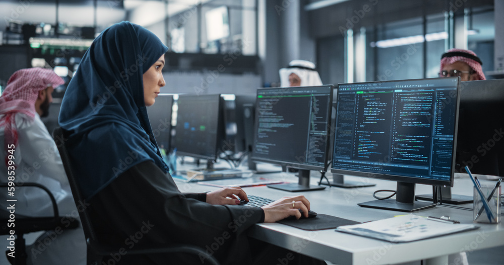 Poster middle eastern female working in a company of arab men in a professional technology enterprise. youn