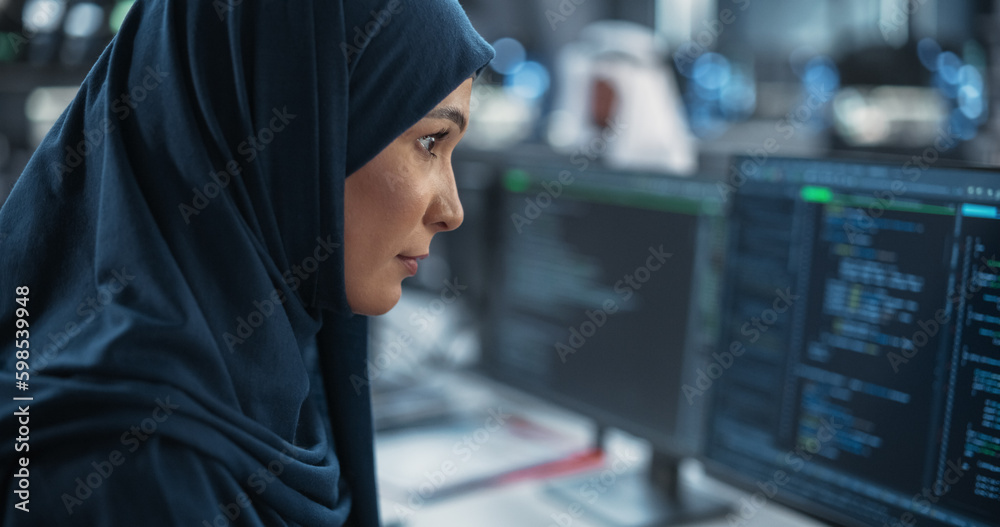 Poster Portrait of a Smart Focused Middle Eastern Engineer Working on Computer in a Technological Corporate Office. Young Arab Woman in Hijab Developing Software for an Innovative Internet Service Provider