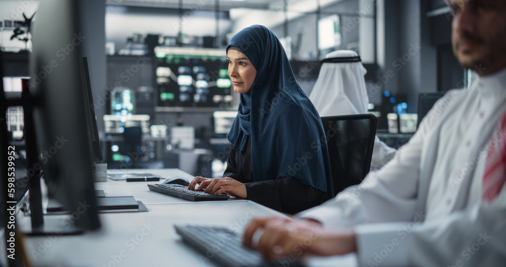 Aufkleber beautiful middle eastern computer scientist wearing a hijab, working on pc in a technological corpor