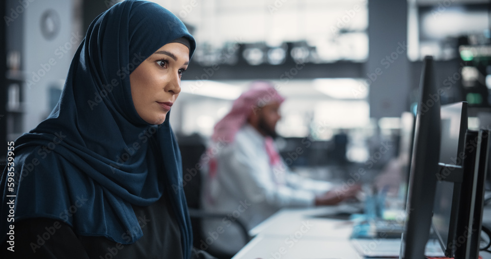 Aufkleber Portrait of a Thoughtful Middle Eastern Engineer Working on Computer in a Technological Corporate Office. Young Woman Writing Software Code for an Innovative Internet and Software as a Service Project
