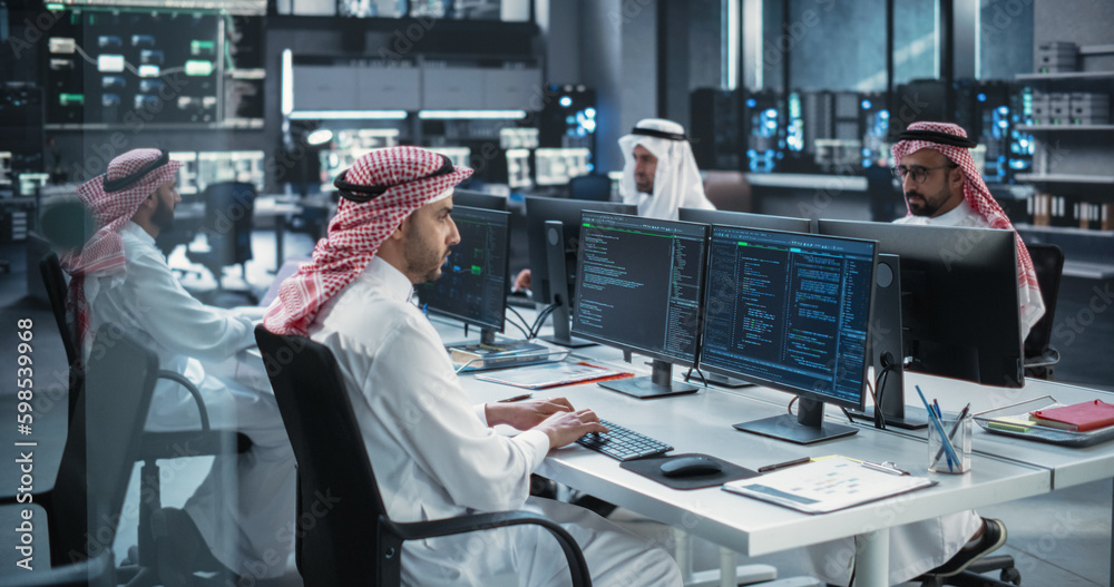 Aufkleber Team of Talented Young Arab Professionals Working in a Technological Research and Development Agency. Computer Screens with Software Code and Technical Neural Network Diagrams in Muslim Office