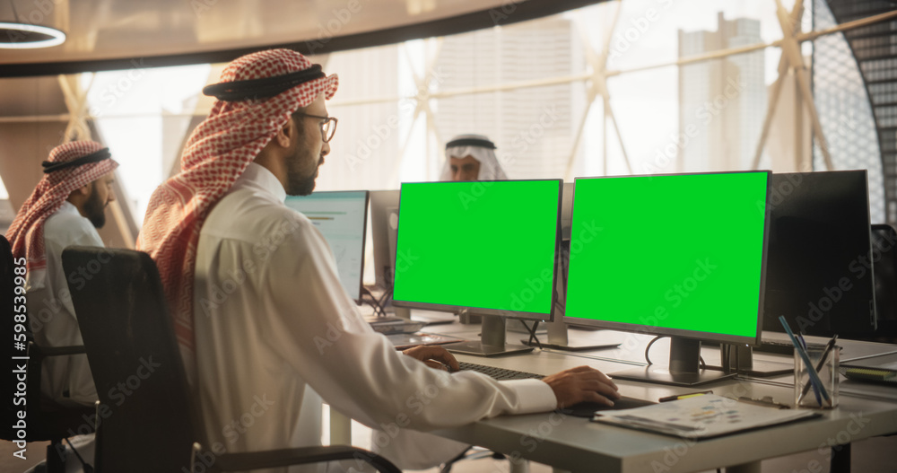 Aufkleber Arab Chief Financial Officer Working on Desktop Computer with Green Screen Mock Up Display. Young Middle Eastern Specialist Analyzing Corporate Banking Account, Researching Investment Opportunities