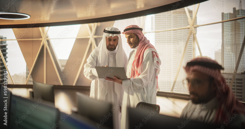 Aufkleber two young muslim financial advisers use laptop computer to discuss a stock market strategy in a mode