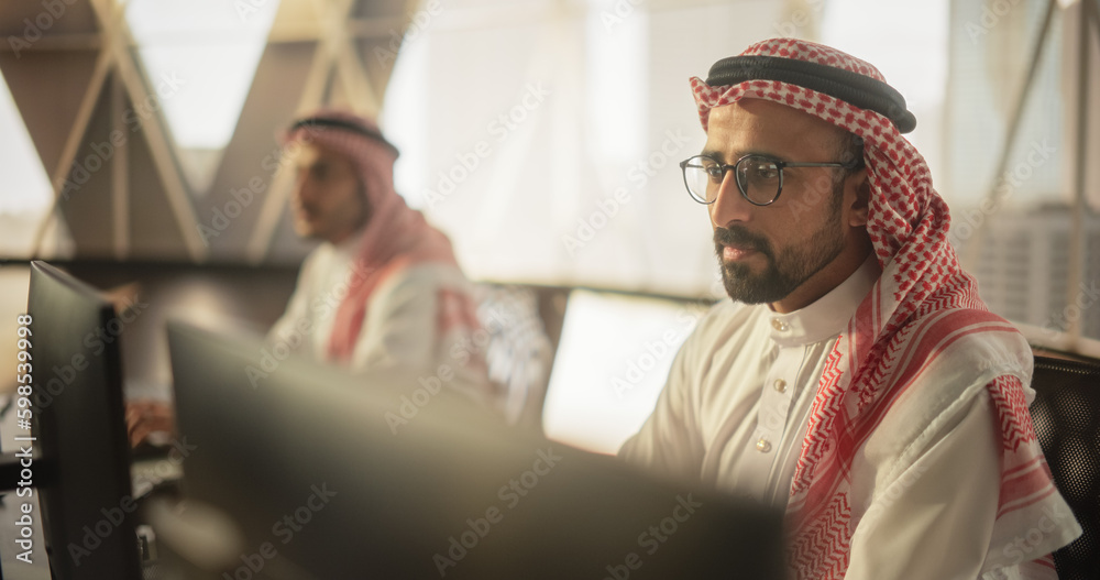 Aufkleber Portrait of a Middle Eastern Software Developer Working on Computer in a Technological Corporate Office. Young Muslim Woman Conducting Business Investment Research for a Fintech Startup Company