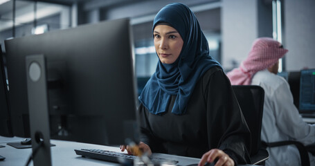 Young Arab Female Artificial Intelligence Engineer Working on Computer in a Technological Office....