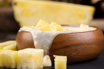 milk pineapple yogurt with pieces of pineapple and other fruits