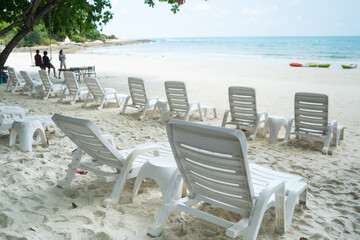 Beach bed ,white plastic beds or trampoline bench with in sea beach tropical for tourists to rest on summer holiday with bright blue sky background.