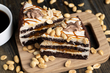a piece of chocolate cake with caramel and peanuts